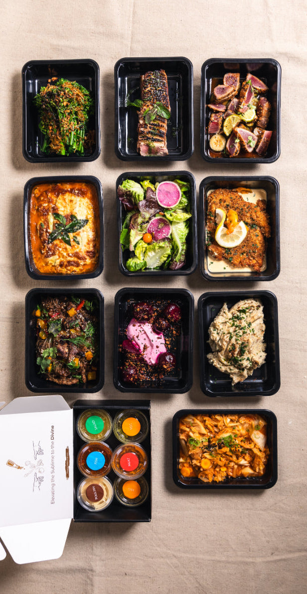 Assorted Gourmet Animal meals  in black containers on a beige surface with a white box.